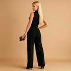 Women’s chic wrap jumpsuit with tailored waist and wide-leg silhouette, available in classic colors, perfect for formal and business occasions.