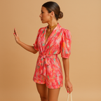 Women’s printed short jumpsuit with a flattering waist belt and vibrant design, perfect for summer days, casual outings, and evenings out.
